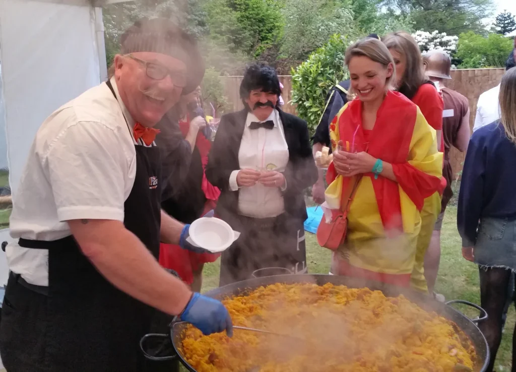 Gary cooking paella at a private fancy dress party