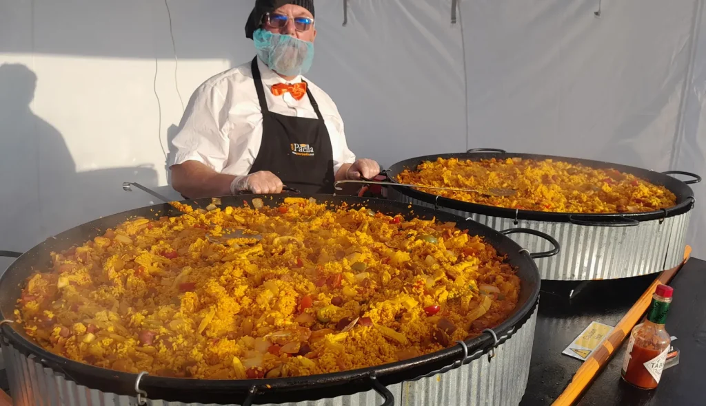 Gary from your paella with two large paella pans filled with freshly cooked paella